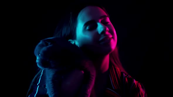 Pets and People Concept  Happy Young Woman with Cat in Neon Lihgt