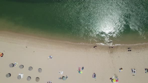 Vila Nova de Milfontes beach Shore, tourists at shoreline, Alentejo. Portugal, Topdown view alt