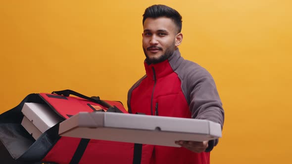 Indian Man with Food Delivery Bag in One Hand Giving Pizza to the Customer alt