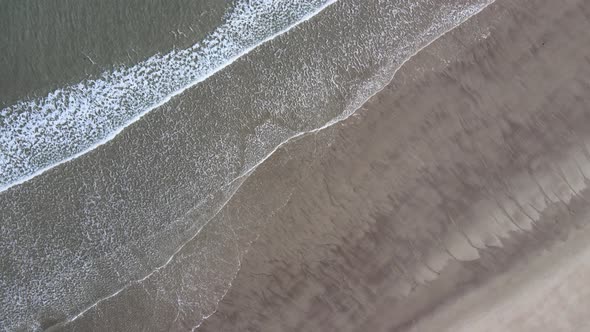 Aerial Top View of Old Wrecked Fishing Ships Drowned at the Sea Shore in Snowy Winter Season alt