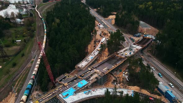 Aerial View Over Cistern Train and Cars Moving By New Bridge Construction Site alt