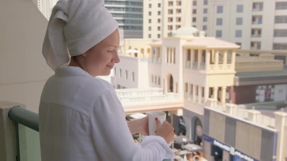Woman Standing with a Cup of Hot Drink on the Balcony of the Hotel on a Vacation