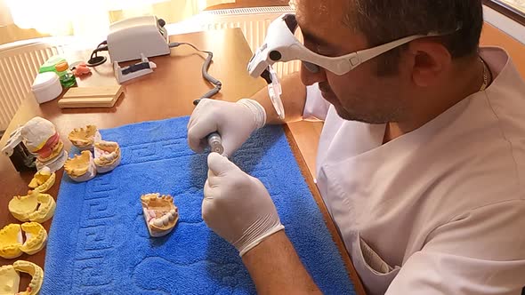 Dental Technician Polishing A Tooth