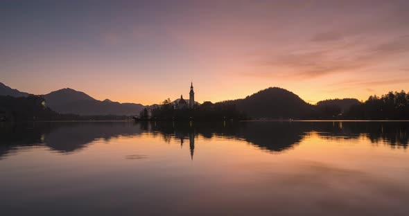 Timelapse View of the Colorful Forest and Lake Bled with a Small Island with a Church. Sunrise