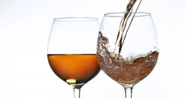 900091 Pink Wine being poured into Glass, against White Background, Slow motion 4K alt