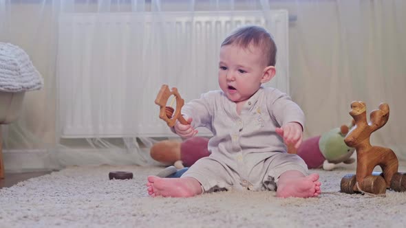 Mother teaches happy baby to walk, first steps, age eight months