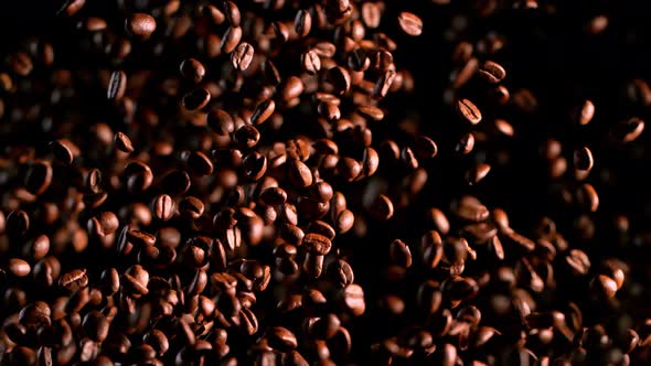 Super Slow Motion Shot of Exploding Premium Coffee Beans Isolated on Black at 1000Fps alt