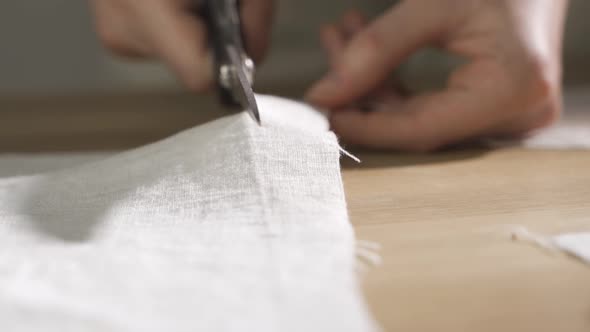 Tailor Work Process of Creating From Fabric Cutting Along the Tailor Chalk Markings Edge alt