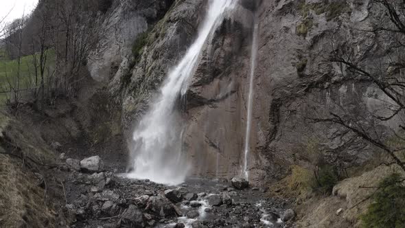 Drone view of a waterfall in the Swiss Alps alt