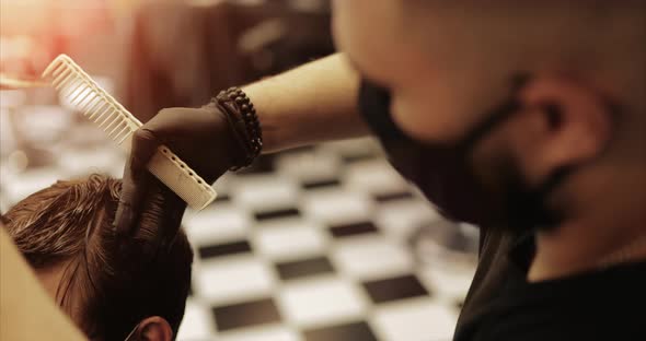 Hair Care. Men's Haircut in a Barbershop. Haircut with Scissors.  alt