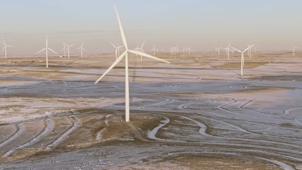 Aerial shots of wind turbines on a cold winter afternoon in Calhan, Colorado alt