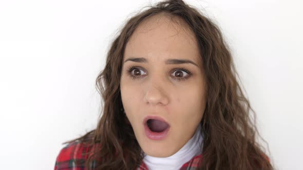 Portrait of Young Surprised and Shocked Teen Girl on a White Background