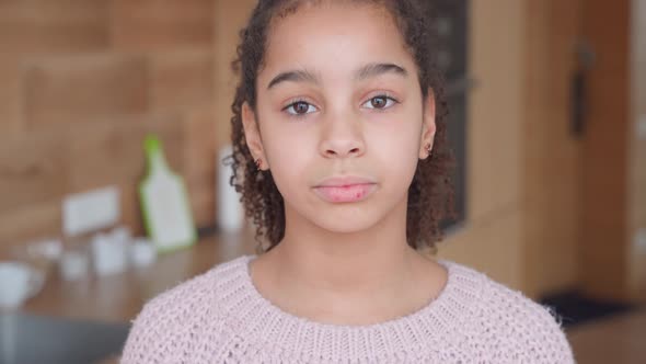 Headshot Portrait of Sad African American Teen Girl Looking at Camera at Home alt
