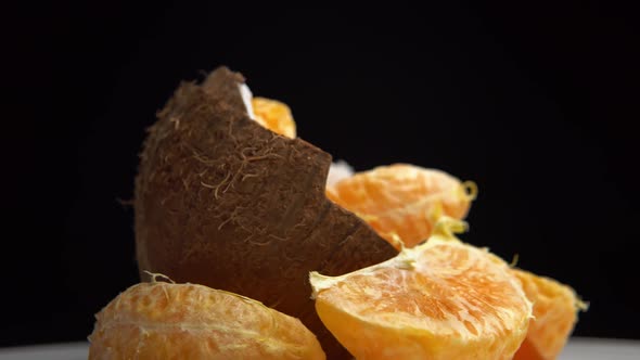 Half a Coconut with Ripe Fresh Mandarin Slices