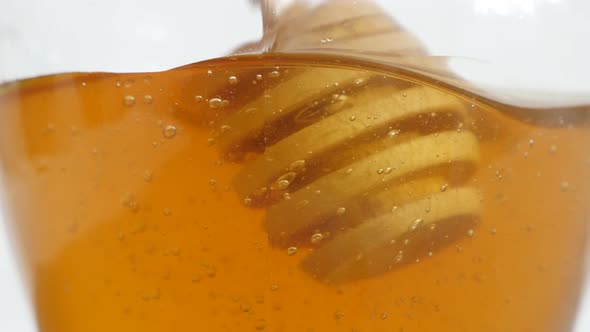 Wooden utensil in sweet food substance 4K 2160p 30fps UltraHD footage - Close-up of honey dipper  us