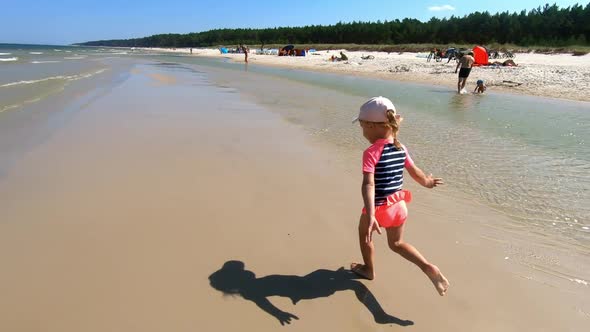 Little Girl Running On Beach.