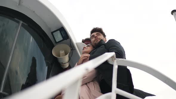 Couple Hugging on a Yacht in Cloudy Weather