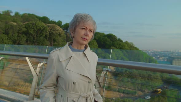 Elderly Bearded Man Approaching Grey Head Woman and Presenting Flowers alt