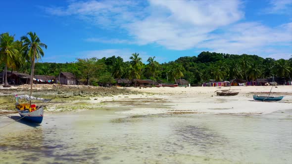 beach scene with dhow fishing boats and white sand in Madagascar alt