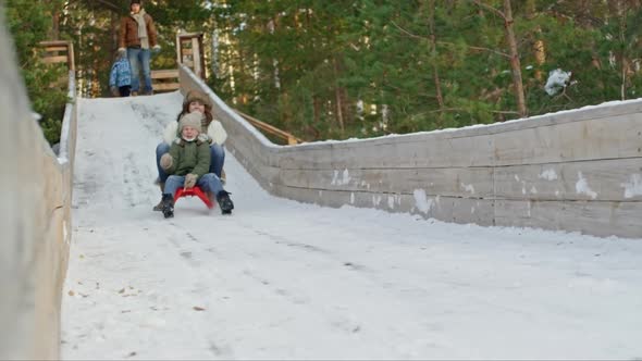 Screaming Woman and Boy on Sled alt