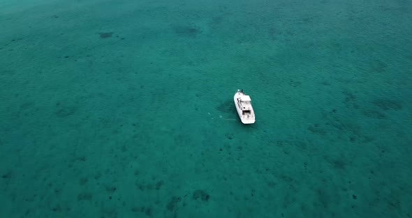 Small yacht in a coral bay in the Caribbean