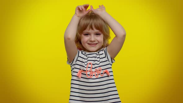 Funny Lovely Teen Kid Child Girl Smiling Friendly and Doing Bunny Ears Gesture on Head Having Fun alt