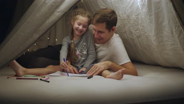 A Happy Father with His Little Daughter in a Makeshift Tent in the House