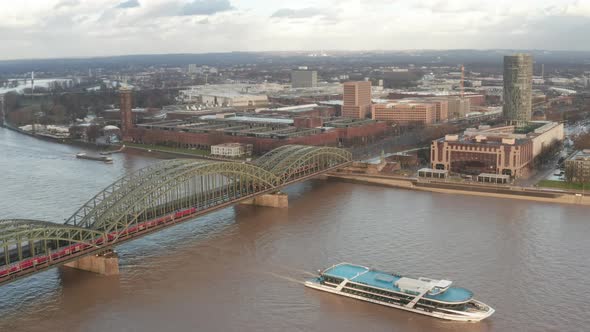 Over Cologne Old Town and View on Rhine and Hohenzollern Bridge with Train Crossing and Boat alt