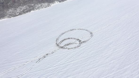 Vehicle tire prints in white snow 4K aerial video