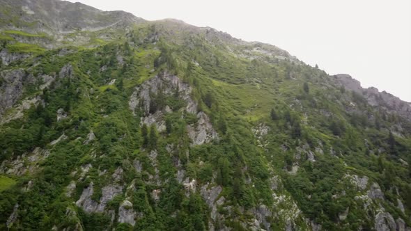 aerial drone view of the rocky facade of a mountain in the swiss alps. alt