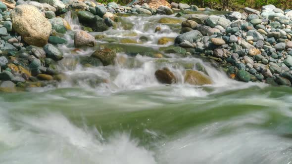 8K Clear River Flowing on Mossy Stones in Forest