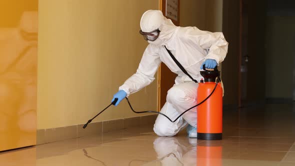 Person in Protective Suit Mask and Goggles Disinfects Corridors Indoors  Movie alt