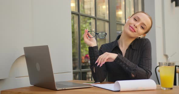 A Businesswoman Is Taking Off Her Glasses and Taking a Break From Work alt