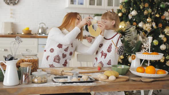 Happy Mother and Daughter Together in the Kitchen Prepare Cookies for the New Year and Have Fun with