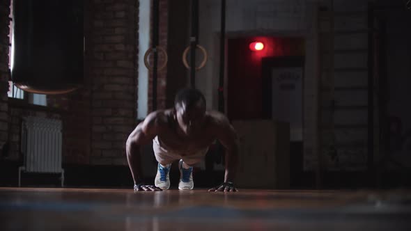 A Black Handsome Man Training in the Gym  Doing Push Ups alt