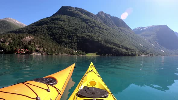 Two kayaks floating around together at lake Lovatnet Norway during a beautiful summer day - Handheld alt