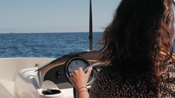 Beautiful Attractive Sailor Girl Driving a Rent Small Boat Yacht alt