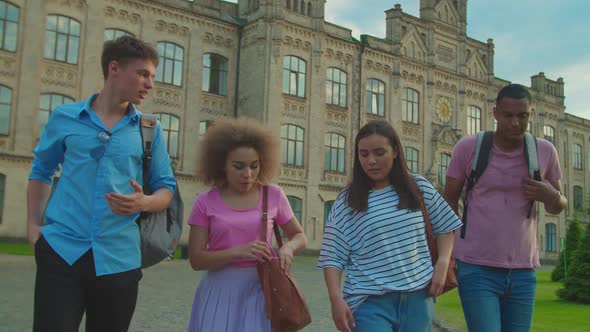 Multiracial Students Getting Notification with Exam Results Outdoors alt