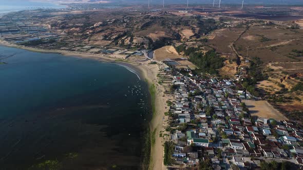 Son Hai fishing village and salt fields, Ninh Thuan, Vietnam coastline aerial alt