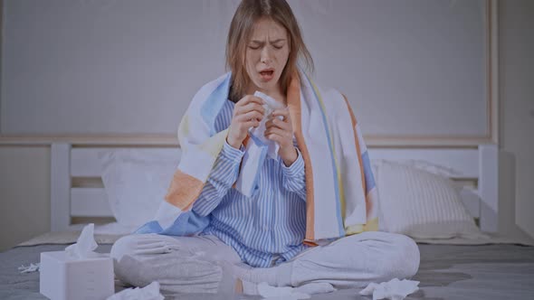 Sick Female with Cold in the Head Sits in Bedroom