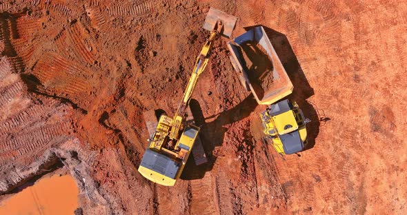 Preparing Place to Construction Residential House on Tractor Bucket is Filling a Soil in Truck alt