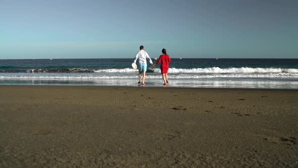 Couple in Love Carefree Running to the Water on the Beach alt