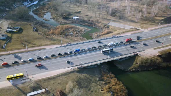 Suburb of a big city. City Park. City highway with busy traffic. Spring cityscape. Aerial photograph alt