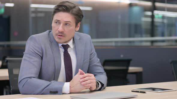 Anxious Businessman Checking Smartwatch while Waiting  alt