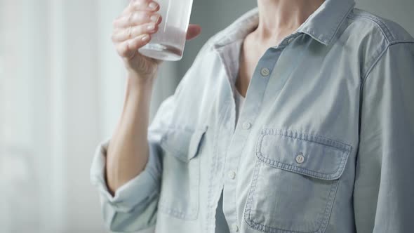 Healthy Woman Drinking Sparkling Water at Home, Freshness and Dieting, Closeup alt