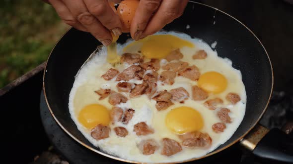Closeup of Broken Egg Falls Into the Frying Pan