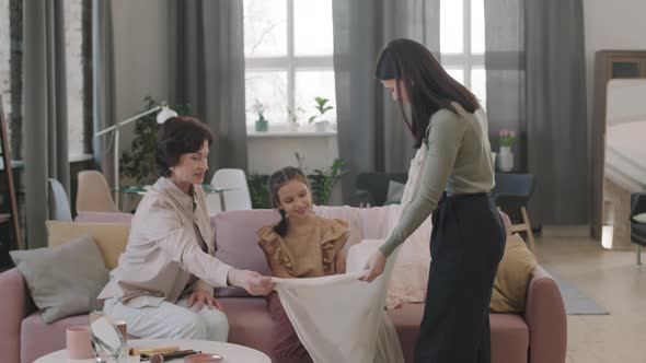 Attractive Woman Choosing Festive Dress At Home alt