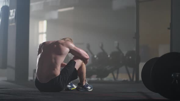 Exhausted Young Men Resting After Intensive Workout in Gym alt