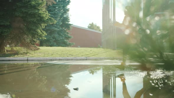 Slow Motion of Pretty Asian Girl in Raincoat and Gumboots Running in Puddles alt