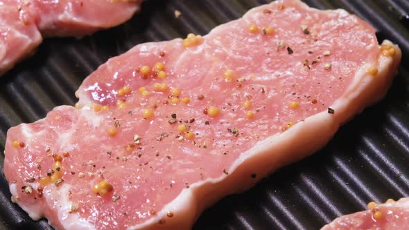 Grilled Pork Steaks Sprinkled with Ground Pepper and Spices